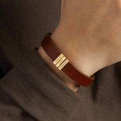 "This leather bracelet is engraved with kids' names. Available in sterling silver with 18K gold plate options, this is the perfect gift for Dad on Father's day, at Christmas or a special day. You can select the number of kids' charms P R O D U C T ∙ I N F O * Word limit: 9 letters/charm * Materials: Genuine Leather with sterling silver charms. * Finishing: Silver, Gold * Dimensions: Leather width measures .approx 3/8\"\" (11mm). The charm measures approx. 1/2\"x 1/8\" (13x3mm). * Size: We have 3 Modern Bracelets For Father's Day Gift, Modern Bracelet For Father's Day Gift, Luxury Name Bracelet As Gift, Customizable Name Bracelet For Father's Day, Personalized Elegant Leather Bracelet As Gift, Classic Leather Bracelet With Engraving Option As A Gift, Personalized Elegant Leather Bracelet Gift, Elegant Personalized Leather Bracelet For Gift, Elegant Personalized Leather Bracelet Gift