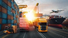 cargo trucks driving down the road with an airplane in the sky above them and shipping containers on either side