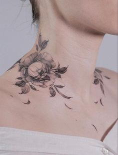 a woman's neck with flowers on it