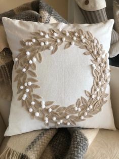 a white pillow sitting on top of a couch