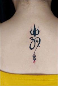 the back of a woman's neck with an omen symbol tattoo on it