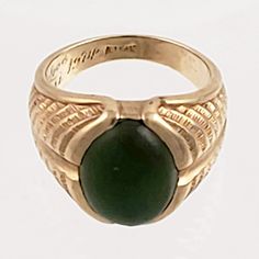 "This striking 14K gold ring features a large green jade stone and an engraved band that resembles a stylized fern or feather. Just the right combination of style and masculinity! Note that the inside of this ring has a lovers inscription and date 1974. Style: Classic, Masculine Vintage: 1970s Materials: 14K Gold, Green Jade Size: 10 Green Jade: 16mm x 12mm Width North to South: approx. 3/4\" Weight: 7.5 dwt / 11.6 g Condition: Very Good ASK ABOUT OUR FREE LAYAWAY! FREE FULLY INSURED PRIORITY SH Antique Green Emerald Ring With Polished Finish, Heirloom Green 14k Gold Signet Ring, Antique Green Rings With Polished Finish, Vintage Green Signet Ring With Polished Finish, Collectible Green Emerald Ring In 14k Gold, Green 14k Gold Emerald Ring Collectible, Collectible 14k Gold Emerald Ring, Green Carved Rings For Formal Occasions, Green Oval Signet Ring Collectible