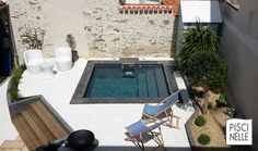 an aerial view of a small backyard with a pool in the middle and chairs around it