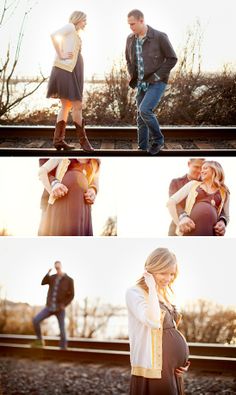 a pregnant woman and man standing next to each other on train tracks