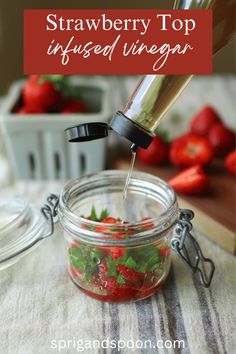 strawberries are being poured into a mason jar with the words strawberry top infused vinegar