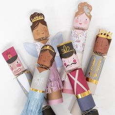 paper dolls made to look like princesses and prince's crowns on top of each other