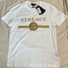 Versace Logo T-Shirt Brand New With Tags Authentic Size Men’s Xs Designer Short Sleeve T-shirt With Logo Detail, White Crew Neck T-shirt With Designer Logo, Luxury Designer Logo Short Sleeve T-shirt, Luxury White T-shirt With Letter Print, Designer Embroidered Logo Crew Neck Top, Designer Crew Neck Tops With Logo Detail, Designer Crew Neck Top With Logo Detail, Designer Crew Neck Top With Embroidered Logo, Designer Logo Crew Neck Top