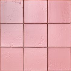 pink tiles are arranged in rows on the wall