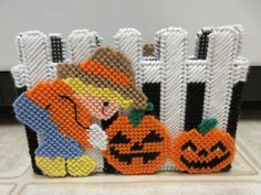 this is a beaded halloween scene with pumpkins