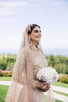 a woman in a wedding dress holding a bouquet and posing for a photo on her instagram page