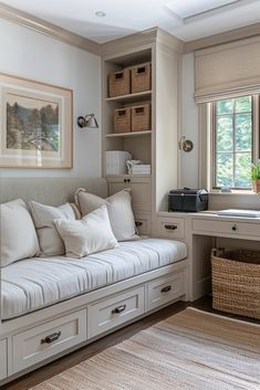 a white couch sitting under a window in a living room