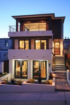 a modern house with stairs leading to the upper floor and second story bedroom above it