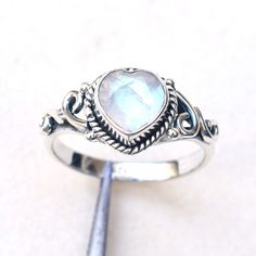 This Ring is handcrafted in Solid 925 Sterling Silver with Natural Rainbow moonstone Heart  gemstone, It is free from lead and nickel to prevent from any type of skin allergies. Product: Ring Metal/Material: 925 Silver Gemstone: Choose a stone option on drop down Stone Type: Cut stone Stone size: 9 mm approx. Stone shape: Heart Weight: 4 gram approx. Birthstone: June Ring Sizes: 4  to 12 US. Select on drop down Stone Setting: Bezel Stone Color: White Finishing: Shiny silver             Gemstone Handmade Sterling Silver Moonstone Promise Ring, Bohemian Heart-shaped Anniversary Rings, Handmade Bohemian Heart-shaped Rings, Heart-cut Sterling Silver Crystal Ring, Handmade Moon-shaped Moonstone Ring In Sterling Silver, Silver Moonstone Birthstone Ring, Oval Cabochon, Bohemian Silver Moonstone Ring Nickel-free, Spiritual Sterling Silver Cabochon Moonstone Ring, Moonstone Ring Sterling Silver