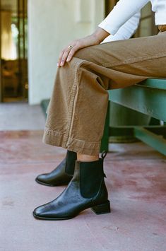 Made in Spain, the Ottavia is our pull-on chelsea boot featuring a square toe and elastic side panels in classic black leather. 1 ½" covered block heel. Padded leather footbed and leather sole. Black Chelsea Boots With Stacked Heel And Square Toe, Classic Black Chelsea Boots With Stacked Heel, Square Toe Chelsea Boots For Fall Workwear, Leather Footbed Chelsea Boots For Workwear, Square Toe Chelsea Boots For Workwear, Fall Workwear Square Toe Chelsea Boots, Black Chelsea Boots With Leather Sole And Low Heel, Black Chelsea Boots With Leather Lining For Fall, Fall Chelsea Boots With Lug Sole And Square Toe