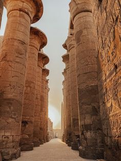 an alley between two large stone pillars in egypt