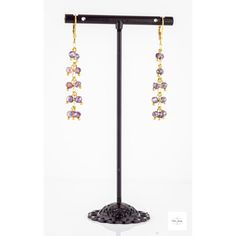 These pretty Purple Glass Fringe Twist Earrings are so fun, and unique! The pretty purple faceted glass beads are complemented by gold-plated Figaro chain. Gold-plated sterling silver lever backs. They are 2 inches long! These dangle earrings are lightweight and lovely! They have a charming little twist in how they dangle!Perfect for adding a touch of girly color and sparkle to any outfit. They are sure to become one of your favorites! Purple Jewelry With Gold Beads For Party, Purple Dangling Beads Jewelry For Party, Gift Purple Jewelry With Dangling Beads, Elegant Purple Jewelry With Gold Beads, Purple Dangling Beads Earrings For Party, Purple Gold Beaded Party Jewelry, Purple Metal Chandelier Earrings As Gift, Party Jewelry In Gold With Amethyst, Gold Amethyst Jewelry For Party