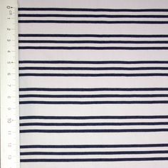 a ruler is next to a white and black striped fabric