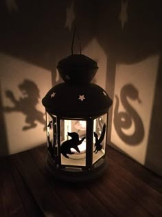 the shadow of a cat in a lantern on a table