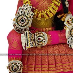 Design by Classical Dance Jewelry® ❥ Product Details: Designer Goddess Vara Lakshmi idol ❥ Material is mixed Alloys ❥ Color: Pink and Gold ❥ Beautiful saree deign Goddess Lakshmi in sitting posture ❥ Beautifully decorated mask used for pooja during Varalakshmi Vratham ❥ Completely Decorated with High Quality Stones and pearls Height of Ammavari Idol : 19-20 Inchs ( Large Size) Set includes ☛ Lakshmi Idol : 1 ☛ Lakshmi Mask : 1 ☛ Magalasutram : 1 ☛ Hastalu Padallu : 1 Set ☛ Short Haram : 1 ☛ Long Multicolor Wedding Choli With Latkans, Wedding Multicolor Choli With Latkans, Bollywood Style Sets With Latkans For Traditional Ceremonies, Festive Traditional Wear With Stone Work For Festivals, Festive Choli With Stone Work For Festivals, Traditional Choli With Stone Work For Festivals, Traditional Drape Choli With Stone Work For Festivals, Traditional Draped Choli With Stone Work For Festivals, Wedding Choli With Motifs For Festivals