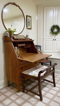 a room with a chair, desk and mirror