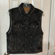 American Eagle Nwt Button Front Denim Vest. New With Tags. Never Worn. 94% Cotton 6% Recycled Cotton. Two Front Chest Pockets With Working Buttons. Two Side Pockets. Measurements: Shoulder To Hem- 22” Pit To Pit - 19 1/2” Spring Washed Black Denim Vest, Washed Black Denim Vest For Fall, Fall Denim Button-up Vest With Snap Buttons, Fall Button-up Denim Vest With Snap Buttons, Washed Black Denim Vest With Pockets, Dark Wash Denim Vest With Buttons For Fall, Fall Denim Vest For Workwear With Buttons, Casual Black Denim Vest With Button Closure, Black Denim Vest For Workwear In Fall