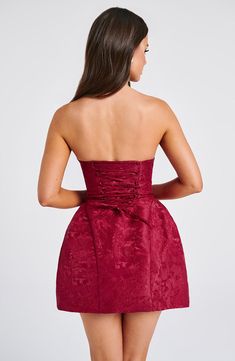 THE dress of the season has landed and you're going to be obsessed. Meet Elenora, our dreamy mini with a pretty structured skirt and waist cinching bodice. This strapless style is complete with lace up and an oversized bow to the back for perfect feminine drama. 



Colour: Red.

Premium non-stretch floral jacquard.

Strapless design.

Waist cinching.

Detachable bow.

Oversized bow detail to back.

Voluminous, structured skirt.

Lace up to the reverse.

Mini length.

Model is an XS and is weari Homecoming Dresses Corset, Structured Skirt, White Dress Spring, Long Sleeve Homecoming Dresses, Split Long Dress, Homecoming Dresses Long, Maxi Dress Sale, Sparkle Dress, Maxi Dress Navy