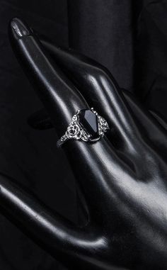 "I'll love you to the tomb and back." Unleash your inner gothic glamour with this stunning ring shaped like a coffin, with the centre featuring a gorgeous black gem, making for a beautifully intricate and unique addition to any outfit. Details: Material: Zinc Alloy Measurements: 1cm wide x 1.5cm tall. Size: Size 7, 8 or 9. Colour: Silver & Black. Gothic Victorian Rings, Coffin Engagement Ring, Goth Rings, Gothic Glamour, Gothic Ring, Black Gems, Witchy Jewelry, Gothic Rings, Victorian Rings