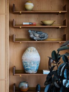 the shelves are filled with vases and other decorative items, including an earthen urn