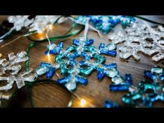 several snowflakes are sitting on a table with string lights in the shape of snowflakes