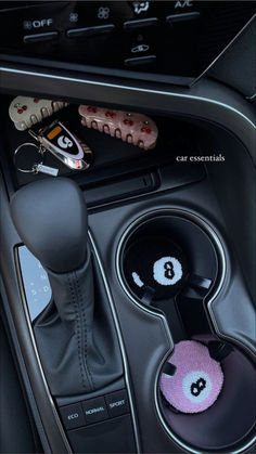 the interior of a car with buttons and steering wheel knobs in it's center console