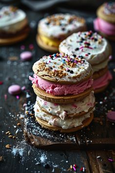 several cookies with frosting and sprinkles stacked on top of each other