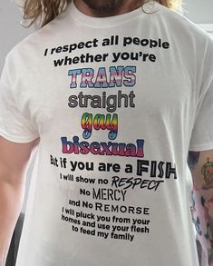 a man with long hair wearing a white t - shirt that says trans straight gay