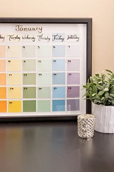 a table with a potted plant and a calendar on it