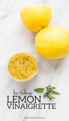 two lemons next to a small cup of tea on a marble counter top with the title how to make lemon vinaigrete