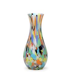 a multicolored glass vase sitting on top of a white table