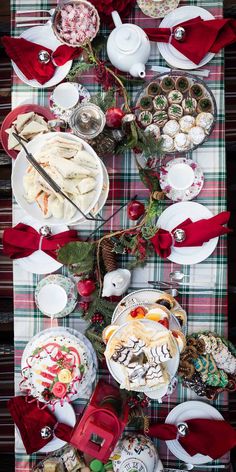 a table topped with lots of plates and bowls filled with food on top of a checkered table cloth