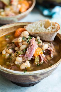 a close up of a bowl of soup with bread