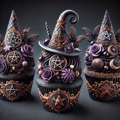 three cupcakes decorated with witches hats and decorations