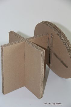 two pieces of cardboard are open on a white surface