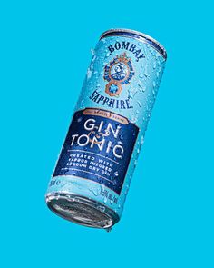 a bottle of gin tonic on a blue background