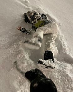 a snowboarder is falling down in the snow