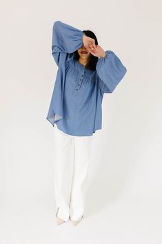 this retro-inspired long sleeve top will take you from summer picnics to fall photoshoots with ease. made with a dark wash denim-esque material, this elevated top features long balloon sleeves + a flowy silhouette. dress it up with trousers + heels, or down with white jeans + sandals. medium wash // high neckline, buttons, balloon sleeves, elastic cuffs paired with our camelot wide leg denim model is 5'8" + wearing a small measurements are approximate + taken while laying flat small : bust 42” l Spring Bishop Sleeve Blouse In Relaxed Fit, Spring Bishop Sleeve Blouse With Relaxed Fit, Relaxed Fit Denim Top For Spring Day Out, Casual Bell Sleeve Blouse For Fall, Summer Peasant Top With Balloon Sleeves And Relaxed Fit, Spring Casual Puff Sleeve Blouse, Fall Denim Puff Sleeve Top, Spring Long Sleeve Peasant Top With Elastic Sleeves, Spring Relaxed Fit Denim Blue Blouse