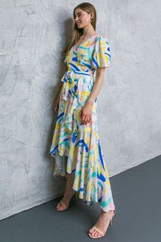 This maxi dress offers an elegant and flattering silhouette with a surplice neckline, flutter sleeves, and a self-tie sash. Its faux wrap design, with a ruffled edge, will ensure your look stands out. Crafted with a lightweight woven fabric, the BEST SHOT WOVEN MAXI DRESS will keep you cool and comfortable in any climate. Details Self: 100% Polyester Lining: 100% Polyester Size & Fit - Model is 5`8 " And Wearing Size Small - Measurements Taken From Size Small - Approx. Length: 58" Spring Flowy Faux Wrap Maxi Dress, Flowy Belted Wrap Dress With Surplice Neckline, Blue Wrap Maxi Dress For Spring, Flowy Belted Maxi Dress With V-neck, Flowy Belted V-neck Maxi Dress, Flowy Midi-length Wrap Dress With Tie Waist, Chic Wrap Dress With Tie Waist And Flutter Sleeves, Flowy V-neck Belted Maxi Dress, Summer Flowy Faux Wrap Dresses