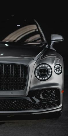 the front end of a silver sports car