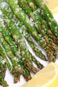 asparagus with parmesan cheese and lemon wedges