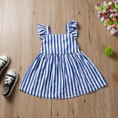 Cute Striped Cotton Dress, Playful Ruffled Sleeveless Beach Dress, Playful Sleeveless Beach Dress With Ruffles, Blue Sleeveless Dress For Beach, Sleeveless Vertical Striped Summer Dresses, Playful Striped Summer Dresses, Blue Cotton Sleeveless Dress With Ruffles, Casual Sleeveless Dress With Vertical Stripes, Striped Cotton Summer Sundress