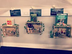 three shelves with books and stuffed animals in them on the side of a white wall