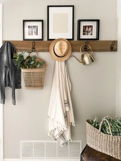 a coat rack with hats and other items hanging on the wall next to a fan