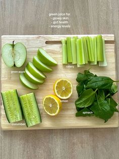 a cutting board topped with sliced up fruit and vegetables