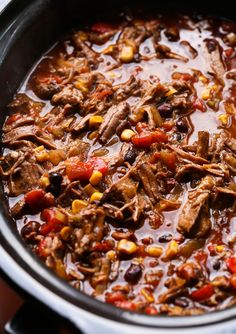 a pot filled with meat and vegetables on top of a stove